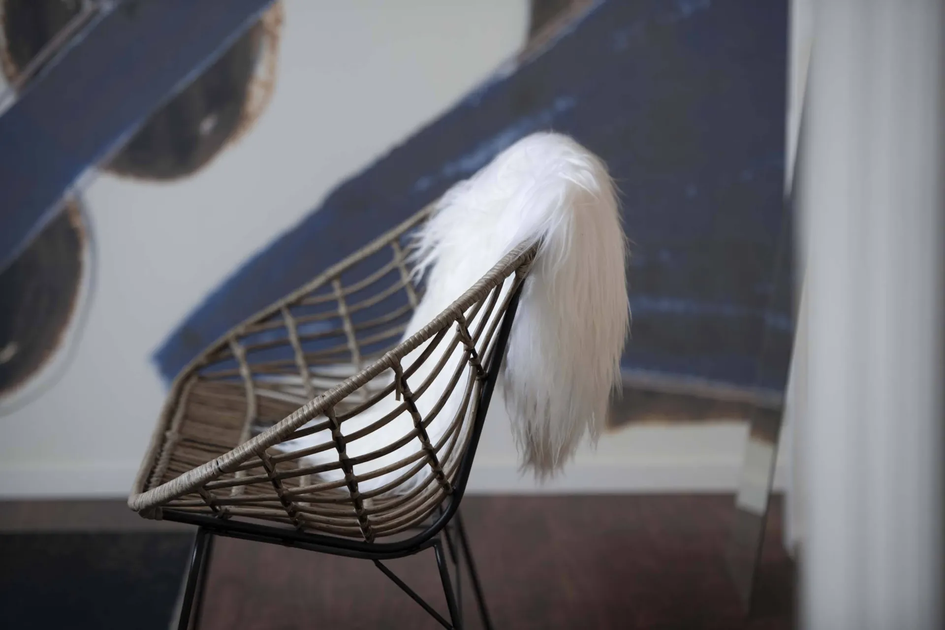 Wicker chair with sheepskin in the suite
